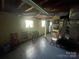 Exposed ceiling in the basement, features durable flooring, and natural light at 739 Owls Den Rd, Lincolnton, NC 28092