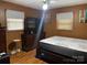 Bedroom featuring brown walls, a new mattress, and a dresser with a television at 739 Owls Den Rd, Lincolnton, NC 28092