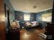 Bedroom with hardwood floors, blue walls and untidy contents at 739 Owls Den Rd, Lincolnton, NC 28092