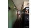 Hallway with green walls, dark wood floors, and several doors leading to other rooms at 739 Owls Den Rd, Lincolnton, NC 28092