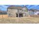 Spacious brick home backyard with a covered patio and plenty of room for outdoor activities and relaxation at 809 Brown Creek Dr, Matthews, NC 28104