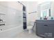 Clean bathroom featuring a tub, toilet, vanity and neutral color palette at 809 Brown Creek Dr, Matthews, NC 28104