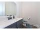 Bathroom with vanity, sink, mirror and toilet with gray paint and ceramic floor tile at 809 Brown Creek Dr, Matthews, NC 28104