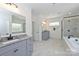 Spacious primary bathroom with separate vanities, granite countertops, and glass enclosed shower at 809 Brown Creek Dr, Matthews, NC 28104