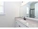 Bright bathroom features a vanity with gray countertops, modern fixtures, and a large framed mirror reflecting the shower at 809 Brown Creek Dr, Matthews, NC 28104