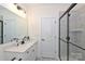 Modern bathroom with sleek vanity, glass shower door, and neutral tile at 809 Brown Creek Dr, Matthews, NC 28104