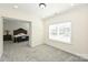 Cozy bedroom featuring neutral walls, carpet flooring, large window, and direct access to the main bedroom at 809 Brown Creek Dr, Matthews, NC 28104