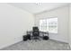 Neutral carpeted bedroom with a modern desk and chair set at 809 Brown Creek Dr, Matthews, NC 28104