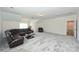 Bright bonus room with carpeting, large sectional sofa, and a doorway at 809 Brown Creek Dr, Matthews, NC 28104