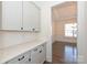 Butler pantry with cabinets, countertop, and hardwood floors leads into the dining area at 809 Brown Creek Dr, Matthews, NC 28104