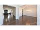 Open-concept dining room features hardwood floors, modern chandelier, and decorative wainscoting at 809 Brown Creek Dr, Matthews, NC 28104