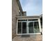 Brick home featuring a sunroom addition with sliding glass doors and a paver patio at 809 Brown Creek Dr, Matthews, NC 28104