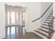 Elegant foyer with gleaming hardwood floors, staircase, and double glass doors at 809 Brown Creek Dr, Matthews, NC 28104