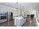 Kitchen with stainless steel appliances, center island, and hardwood floors, offering a modern design at 809 Brown Creek Dr, Matthews, NC 28104