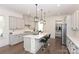 Elegant kitchen with island, pendant lights, and stainless appliances offer a modern cooking space at 809 Brown Creek Dr, Matthews, NC 28104