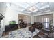 Spacious living room with coffered ceilings and hardwood floors provides an elegant entertaining space at 809 Brown Creek Dr, Matthews, NC 28104