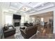 Open living area with fireplace, hardwood floors, and coffered ceilings at 809 Brown Creek Dr, Matthews, NC 28104