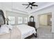 Inviting main bedroom featuring a ceiling fan, a large bed, and access to an ensuite bathroom at 809 Brown Creek Dr, Matthews, NC 28104