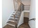 Elegant staircase features hardwood steps, a wood railing with black metal spindles, and an open design at 809 Brown Creek Dr, Matthews, NC 28104