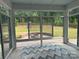 Light-filled sunroom with sliding glass doors offering picturesque backyard views and stone fire pit at 809 Brown Creek Dr, Matthews, NC 28104