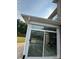 Brick home featuring a sunroom addition with sliding glass doors and a spacious backyard at 809 Brown Creek Dr, Matthews, NC 28104