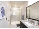 Bathroom featuring a granite topped vanity, glass enclosed shower and decorative painting at 9521 Ainslie Downs St, Charlotte, NC 28273