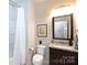 Cozy bathroom with a shower-tub combination, granite countertops, vanity mirror, and ample lighting at 9521 Ainslie Downs St, Charlotte, NC 28273