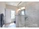 Contemporary bathroom shower features glass doors and tiled walls with decorative shampoo shelves inside at 9521 Ainslie Downs St, Charlotte, NC 28273