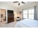 Bedroom featuring a wooden dresser, ceiling fan, a chair and a view into the ensuite bathroom at 9521 Ainslie Downs St, Charlotte, NC 28273