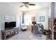 Bright bedroom featuring a neutral color palette, a ceiling fan, and a cozy workspace with desk and chair at 9521 Ainslie Downs St, Charlotte, NC 28273