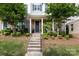 Charming townhome with a stone facade, landscaped front yard, and inviting entryway, creating curb appeal at 9521 Ainslie Downs St, Charlotte, NC 28273