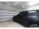 Spacious two-car garage featuring drywall walls and a modern black SUV to showcase potential uses at 9521 Ainslie Downs St, Charlotte, NC 28273