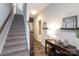 Carpeted hallway with staircase, stylish decor, and doorway views that lead to other rooms in the home at 9521 Ainslie Downs St, Charlotte, NC 28273