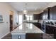 Spacious kitchen with a large granite island and stainless steel appliances at 9521 Ainslie Downs St, Charlotte, NC 28273
