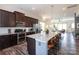 Spacious kitchen with dark cabinetry, stainless steel appliances, and a large granite island at 9521 Ainslie Downs St, Charlotte, NC 28273