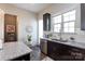 Kitchen with stainless steel appliances, dark cabinetry, and a white subway tile backsplash at 9521 Ainslie Downs St, Charlotte, NC 28273