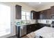Kitchen with stainless steel appliances, dark cabinetry, and a white subway tile backsplash at 9521 Ainslie Downs St, Charlotte, NC 28273