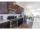Open kitchen featuring stainless steel appliances, dark cabinetry, and granite countertops at 9521 Ainslie Downs St, Charlotte, NC 28273