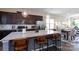 Open kitchen featuring stainless steel appliances, dark cabinetry, and a granite island at 9521 Ainslie Downs St, Charlotte, NC 28273