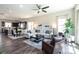 Open-concept living space featuring hardwood floors, modern decor, and a seamless flow to the dining area and kitchen at 9521 Ainslie Downs St, Charlotte, NC 28273