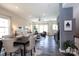Open-concept living and dining area with modern finishes, dark floors, neutral walls, and lots of natural light at 9521 Ainslie Downs St, Charlotte, NC 28273