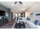 Open-concept living area featuring dark floors, neutral walls, modern furnishings, and an eat-in kitchen at 9521 Ainslie Downs St, Charlotte, NC 28273