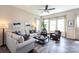 Inviting living room with ample natural light, stylish furnishings, and a ceiling fan, creating a cozy and airy atmosphere at 9521 Ainslie Downs St, Charlotte, NC 28273