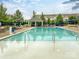 Community pool with a covered pavilion and ample seating for residents to enjoy, surrounded by trees and residential buildings at 9521 Ainslie Downs St, Charlotte, NC 28273