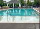 Sparkling community swimming pool featuring poolside seating and a covered gazebo for relaxation on sunny days at 9521 Ainslie Downs St, Charlotte, NC 28273
