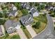 Aerial view of a well-maintained home, showcasing the large driveway and mature landscaping in a quiet neighborhood at 9639 Ravenscroft Nw Ln, Concord, NC 28027