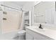 Clean bathroom featuring a shower-tub combo, sink with mirror, and storage at 9639 Ravenscroft Nw Ln, Concord, NC 28027