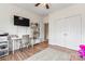 Functional bedroom features hardwood floors, a ceiling fan, and ample storage space at 9639 Ravenscroft Nw Ln, Concord, NC 28027