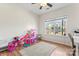 Bright bedroom features hardwood floors, a ceiling fan, and a large window with backyard views at 9639 Ravenscroft Nw Ln, Concord, NC 28027