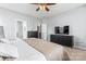 Bright bedroom with a ceiling fan, and black furniture, adjacent to bathroom and closet doors at 9639 Ravenscroft Nw Ln, Concord, NC 28027